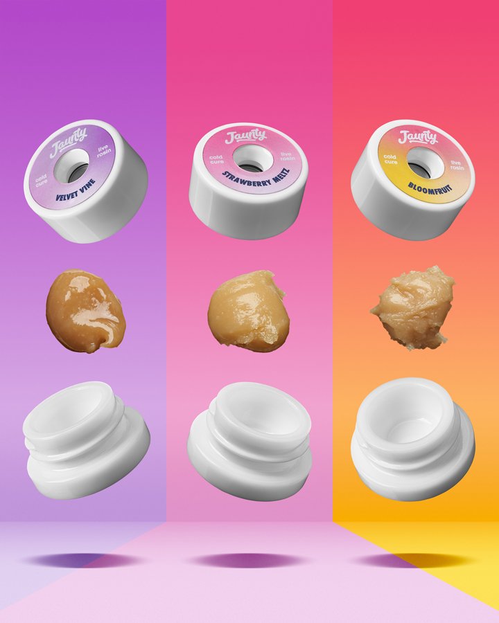 Three containers of flavored lip balm with their corresponding textures and applicator caps: Velvet Vine, Strawberry Mint, and Bloomfruit, on a colorful gradient background.