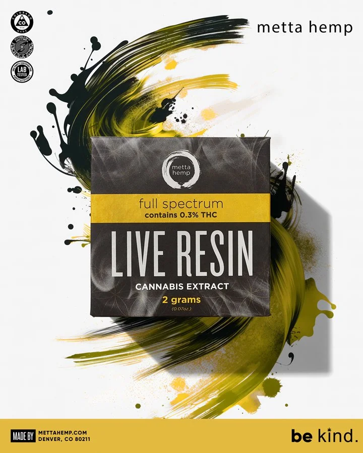 Packaging box of Metta Hemp Live Resin cannabis extract, full spectrum, contains 0.3% THC, 2 grams, black and yellow design with abstract paint splashes, and a yellow band with product details.