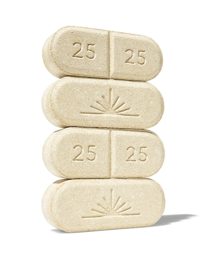 Four white pills stacked vertically, each marked with '25' on both halves, and the second and last pills have a sunburst symbol.