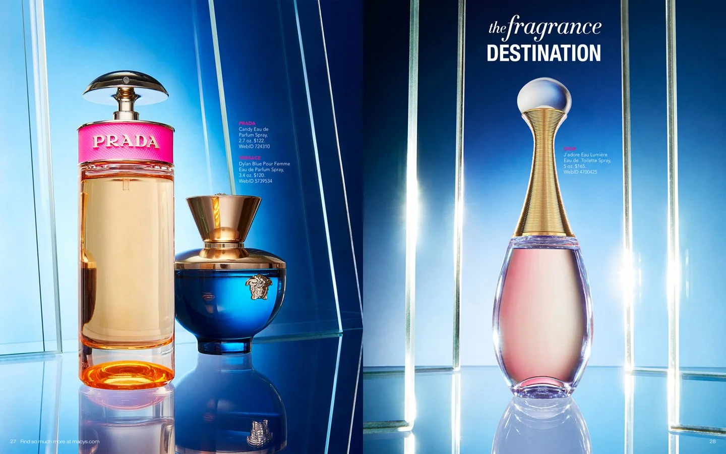 Display of four luxury perfumes on a reflective surface, with blue and mirrored background. The left side features Prada and Versace perfumes, and the right side showcases Dior fragrance with elegant bottle design.