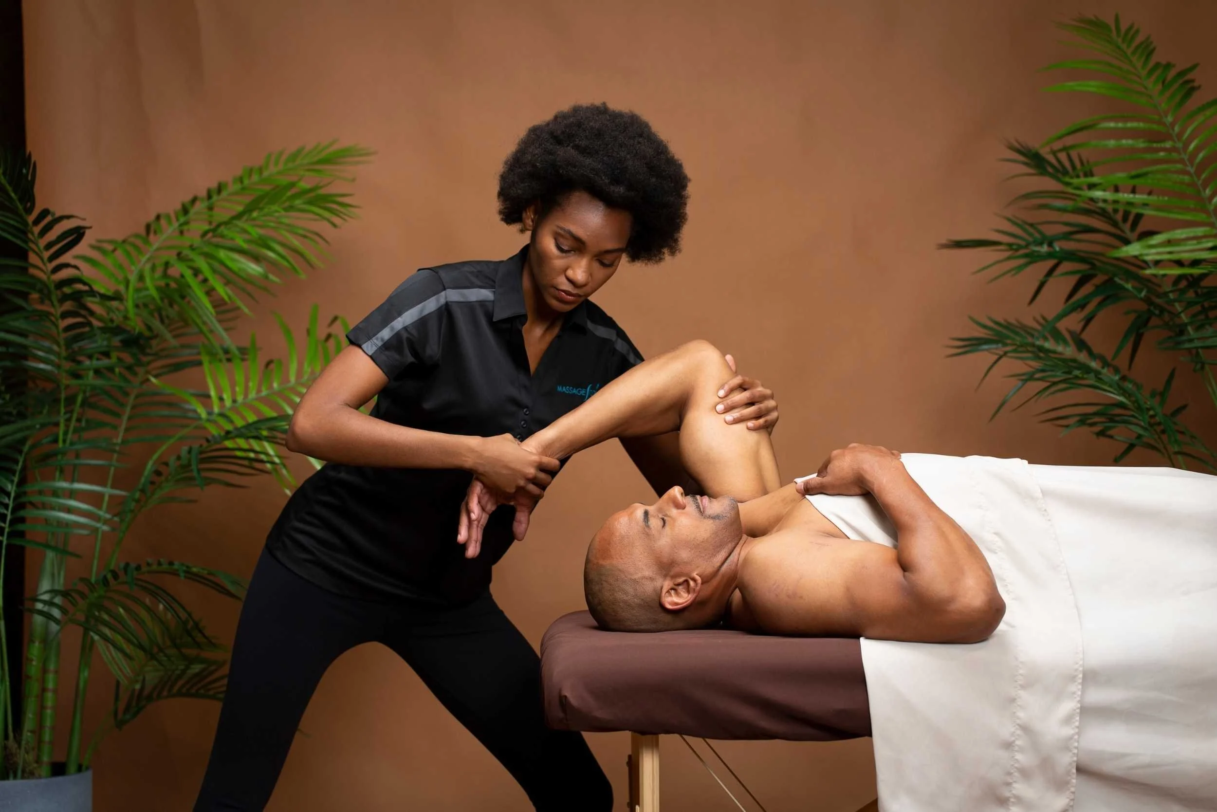 As part of an exercise routine, a man receives a massage to complement his workout