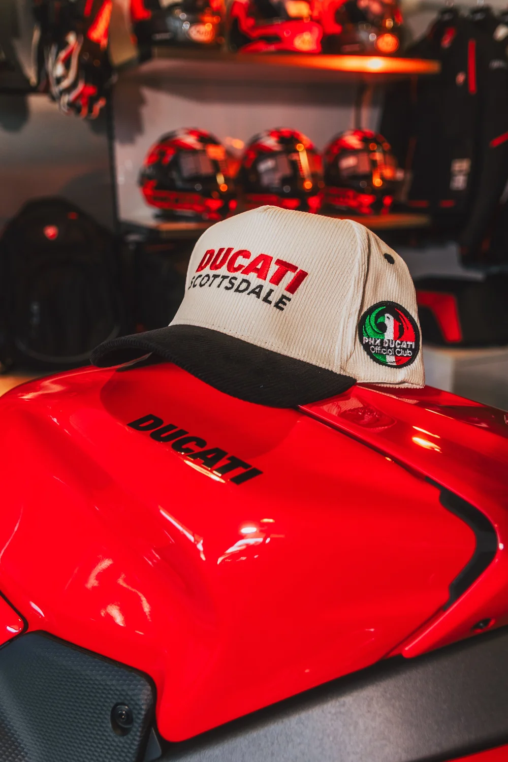PHX Ducati embroidered hat displayed on a red Ducati