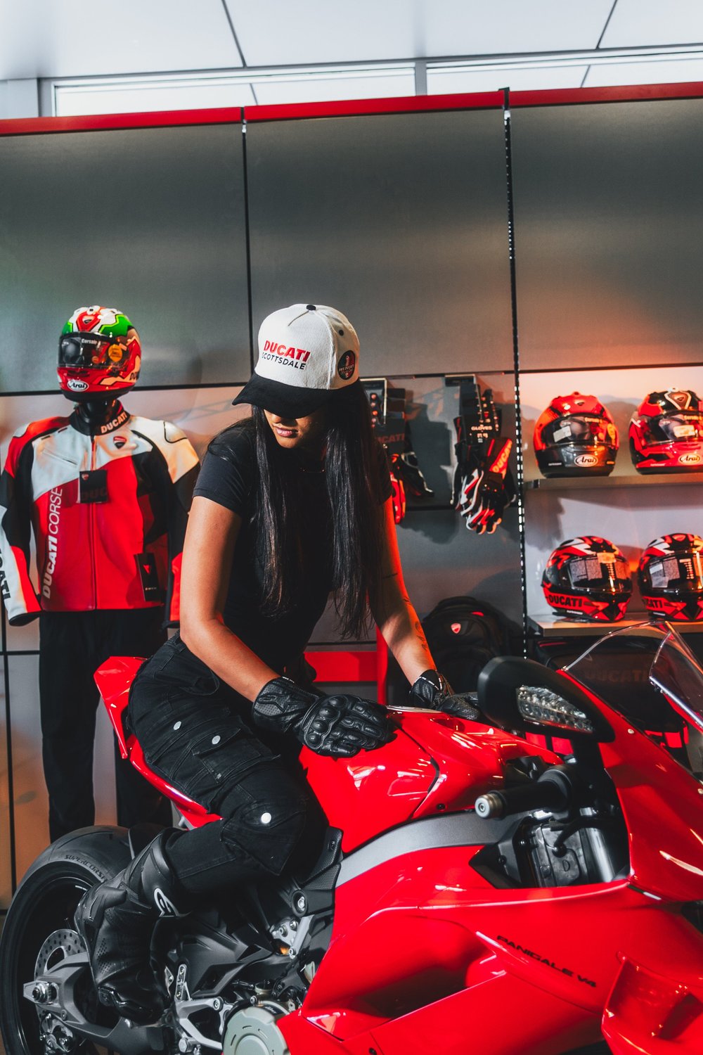 PHX Ducati club hat worn beside a red Ducati