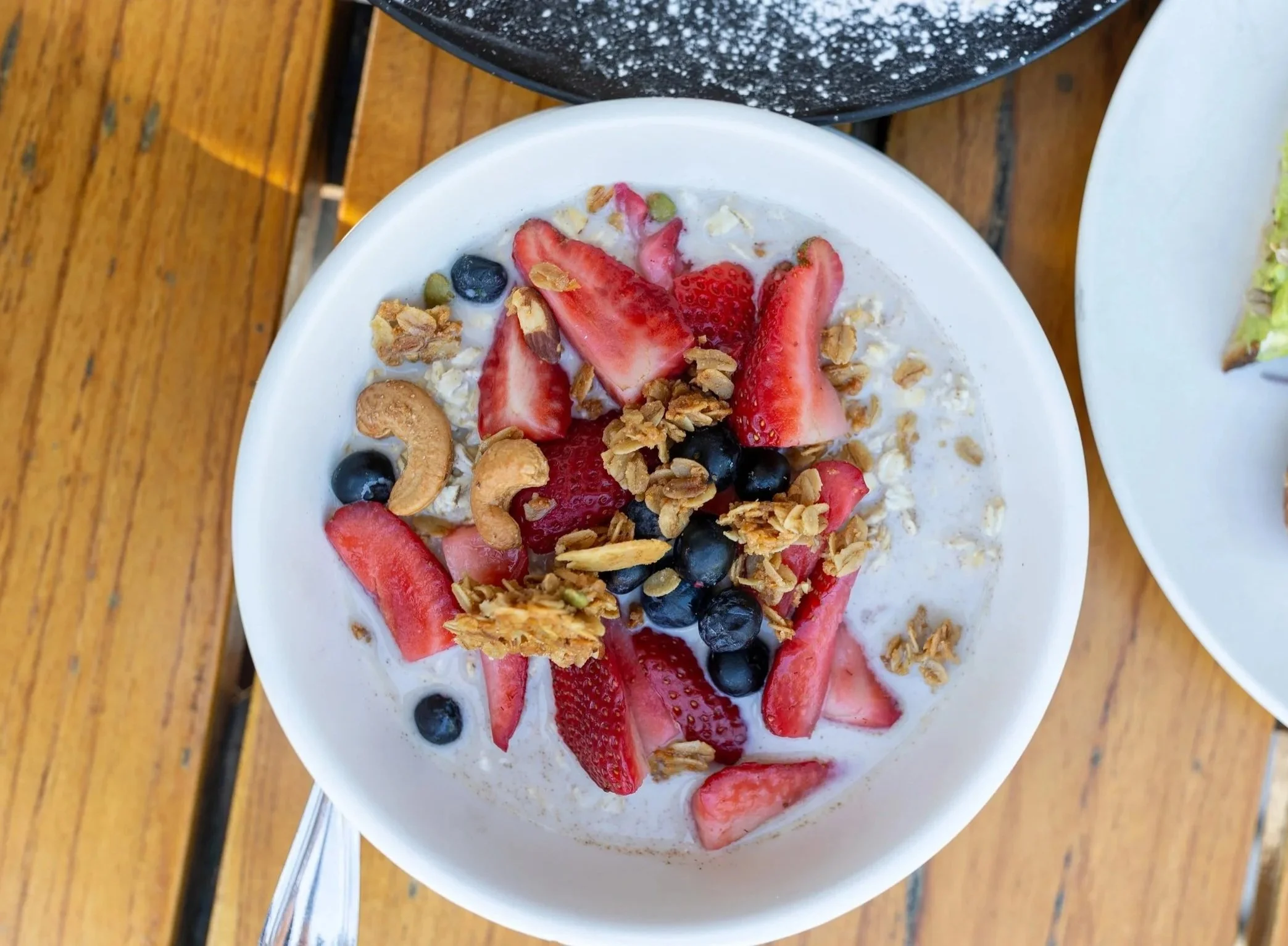  Bowl of yogurt, mixed berries, and granola with nuts 