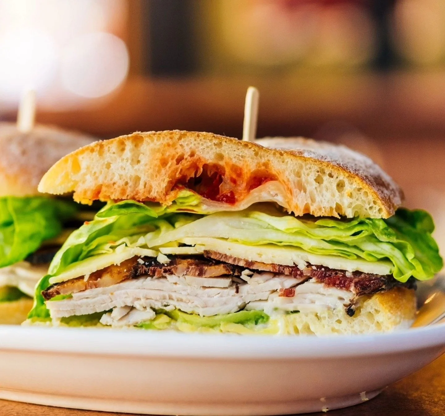 Join us for lunch today and try one of our guests' favorite sandwiches: The Turkey, Bacon, Avocado.  Loaded with turkey, avocado, bacon, smoked cheddar, Dijonnaise, apple chutney, and mixed greens on a fresh baked ciabatta roll.  Yum!