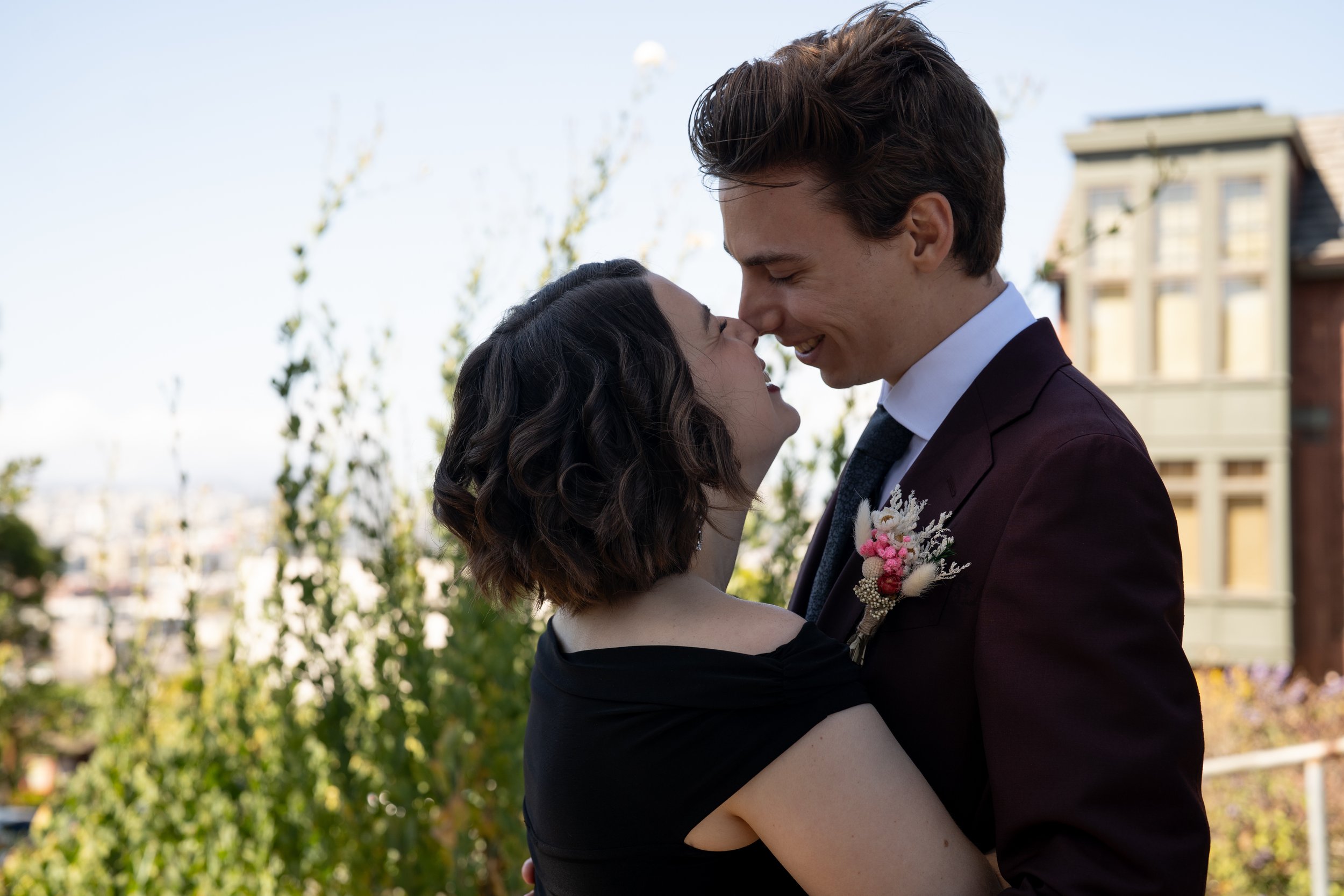 Couple about to kiss on a sunny Potrero Hill street