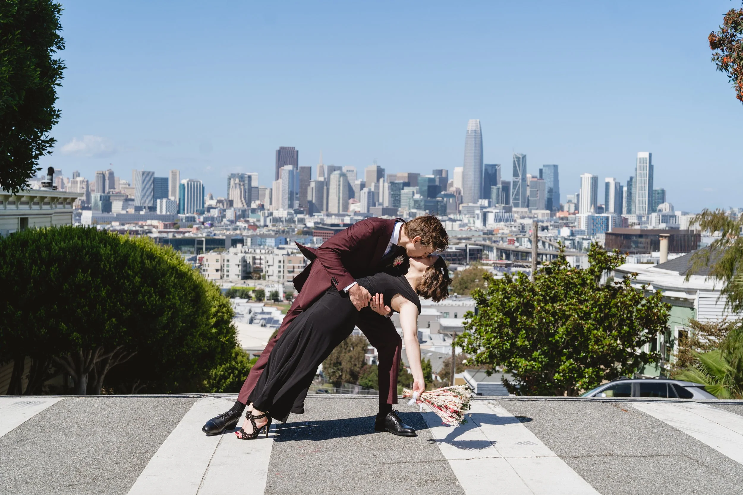 Newly wed couple dip kiss in San Francisco after their elopement.