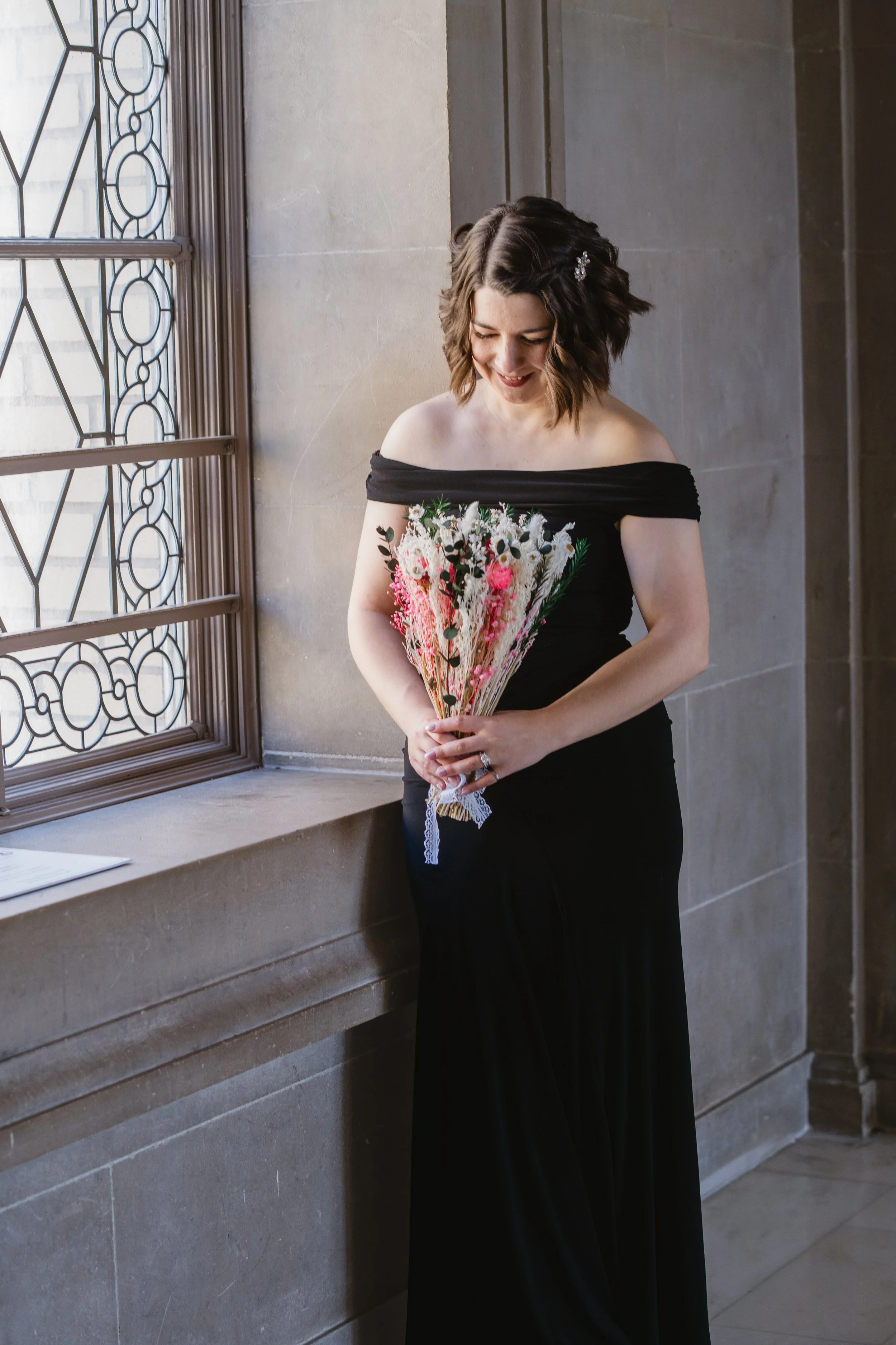 Bride with a dried flower bouquet in window light at SF City Hall