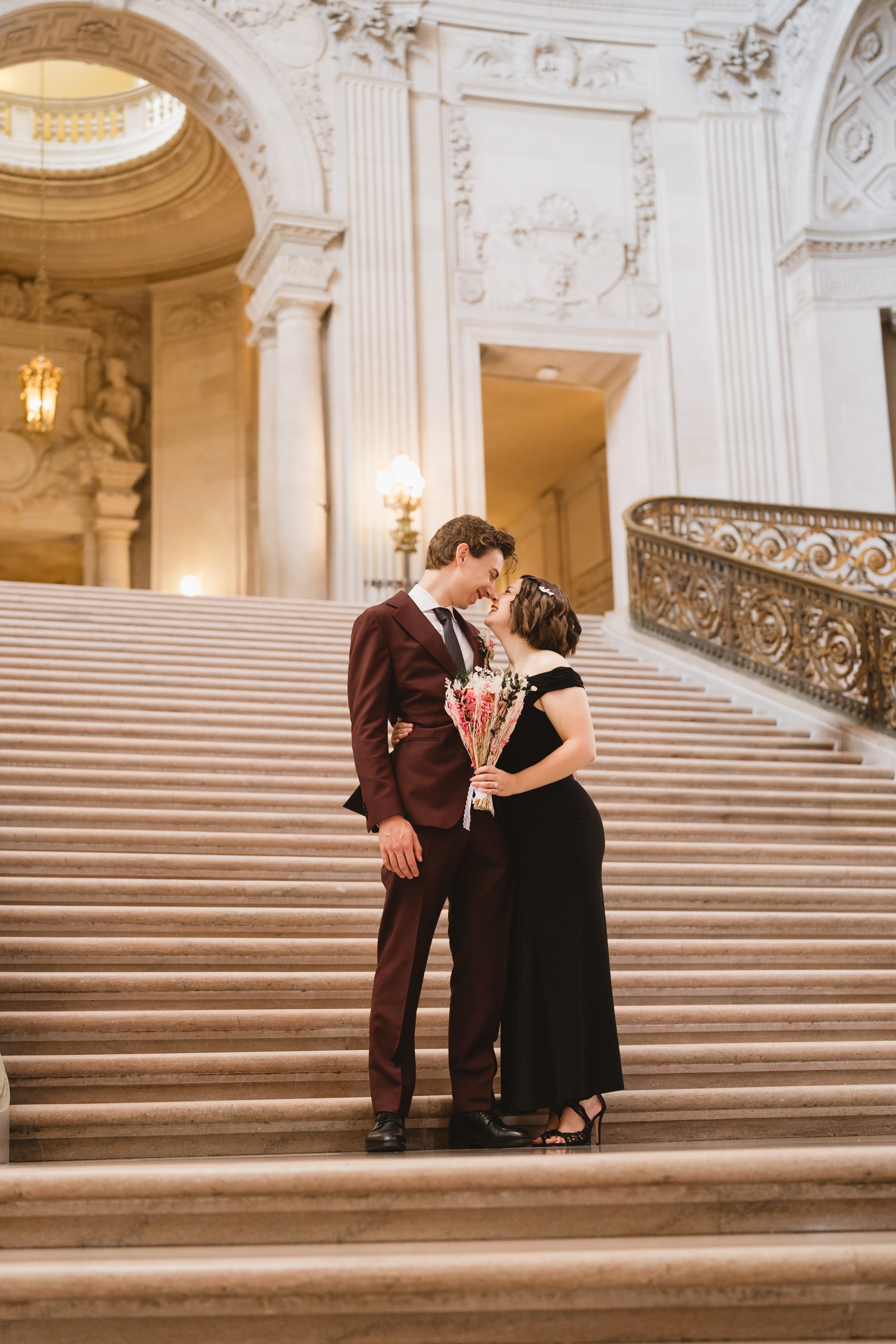 Couple kissing on the Grand Staircase at San Francisco City Hall