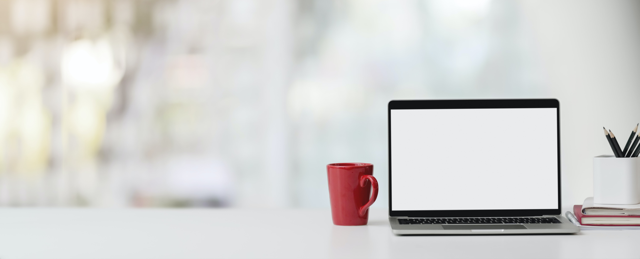 photo-of-laptop-and-red-ceramic-mug-on-white-table-3816186 1.png