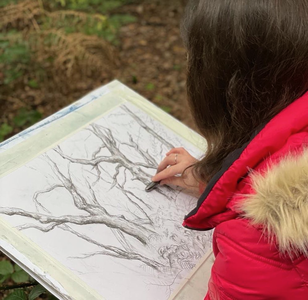 Jennifer Fleming in the forest drawing trees