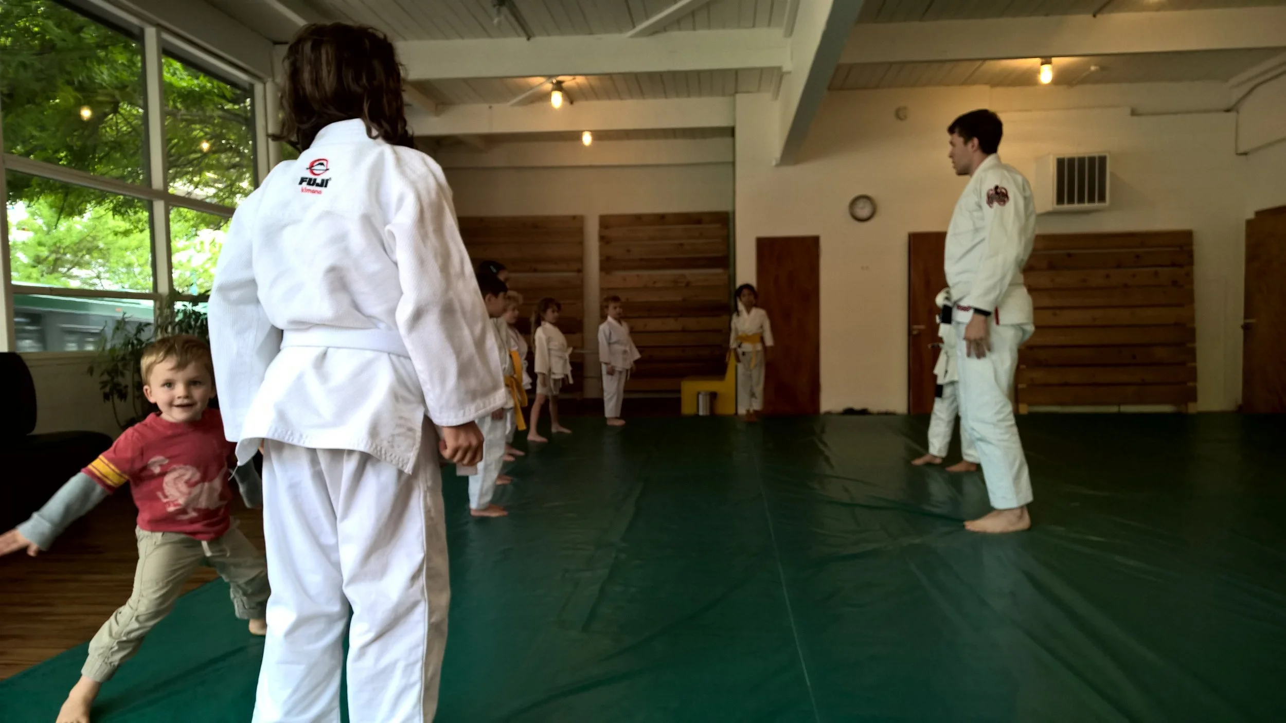 Kids lining up for a brazilian jiu jitsu class