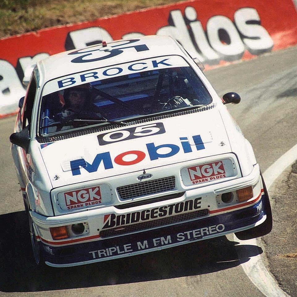 Andy Rouse lifting wheel at The Dipper during the 1989 Bathurst 1000 with Peter Brock Mobil 1 Ford Sierra RS500. Brock was on pole despite big controversy after the scrutineers found a fire extinguisher system nozzle pointed at the intercooler. The p