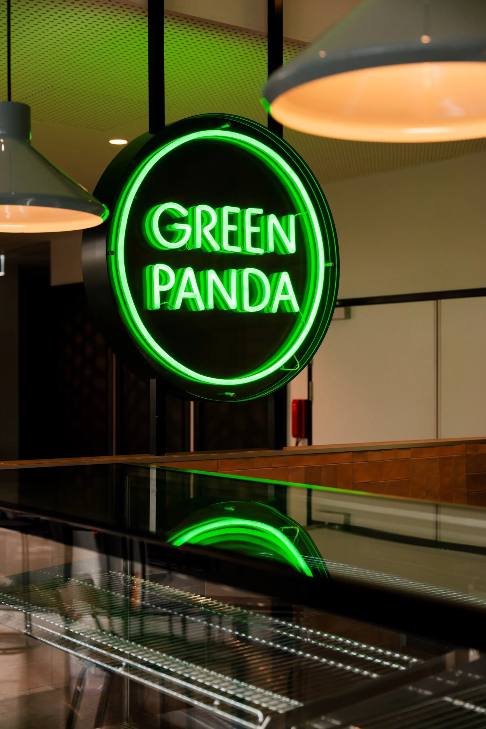 Green Panda Sushi, a compact restaurant fit-out in Hobart with glowing neon signage by Saxon Hall Architecture