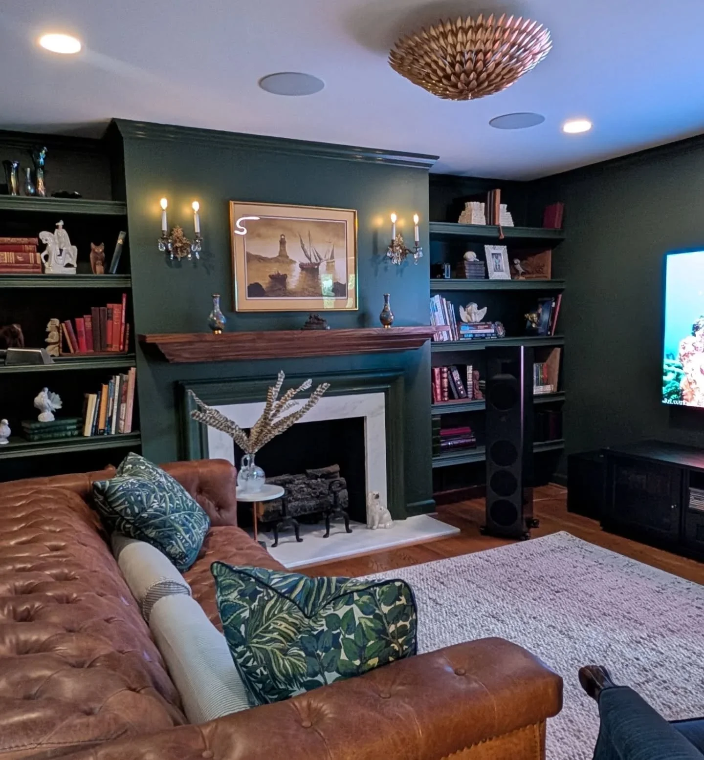 The request was to create a living room/media room that the family could enjoy together. The homeowner had the speakers and media components under control, so we came in to help furnish and decorate the space. 
.
The tone on tone dark green created d