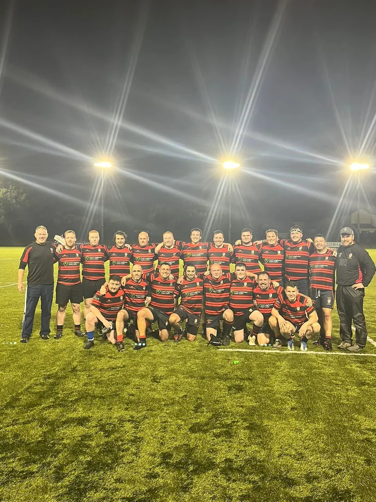 Clane RFC senior team lined up under floodlights