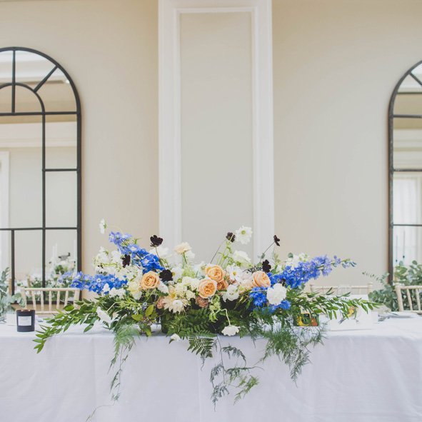 Pastel and blue top wedding table flowers