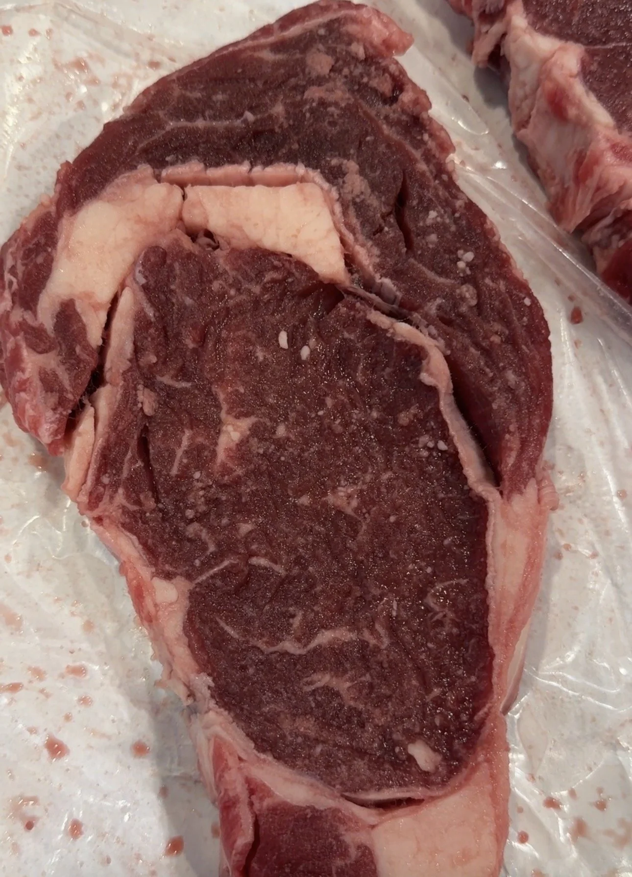 Yes, grass-finished beef should have fat