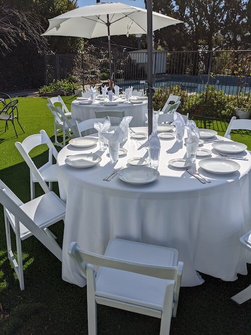 white tablescloth, white resin chairs, dinnerware sets.jpg