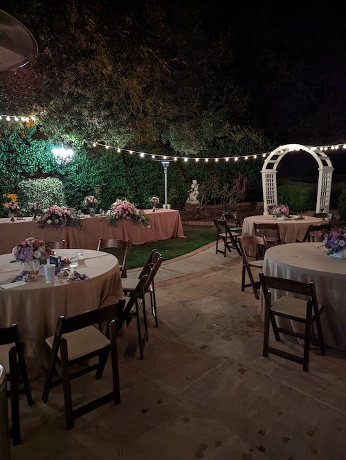 brown wooden chairs with round table with taupe tablecloth.jpg