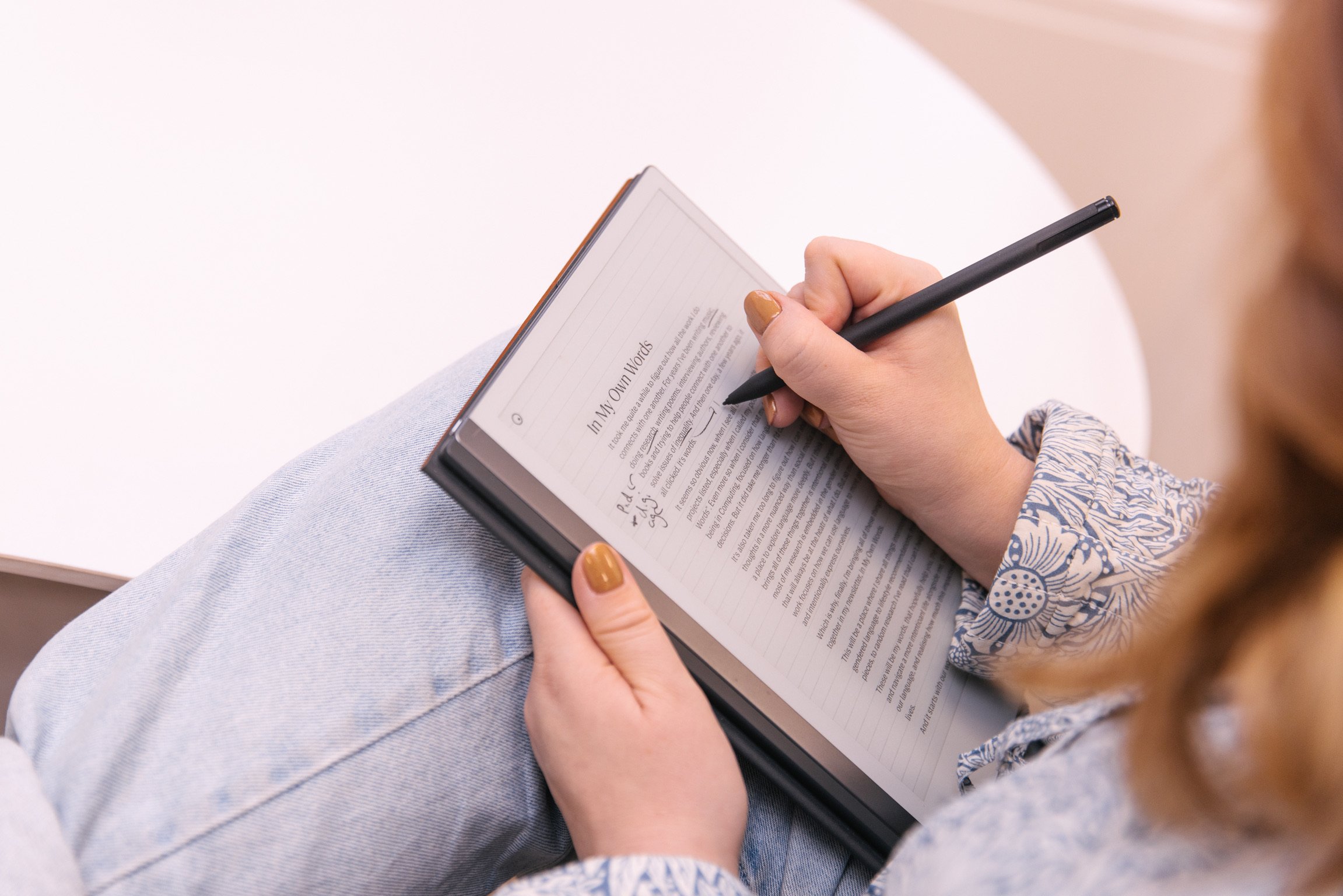 A close up of Alice's hands writing on her tablet and annotating "In My Own Words", the name of her substack