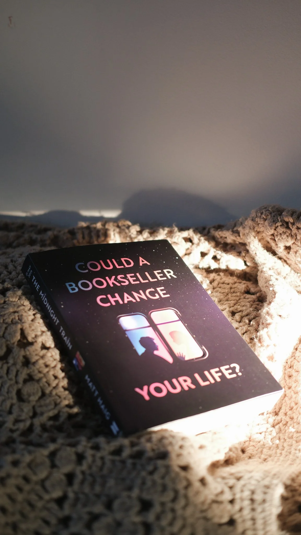 a copy of the midnight train by matt haig lying on a blanket