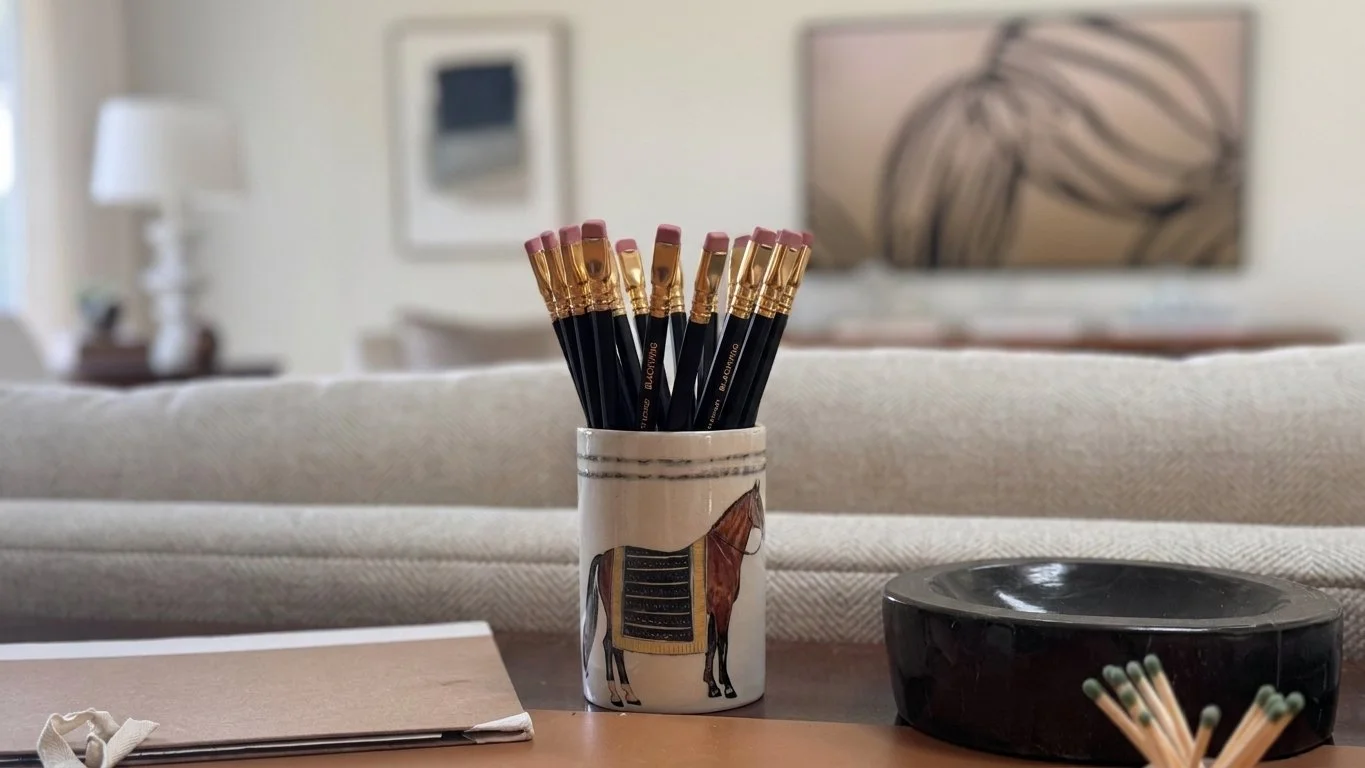 Hand-painted Italian ceramic tumbler with black and gold striped horse blanket design on desk