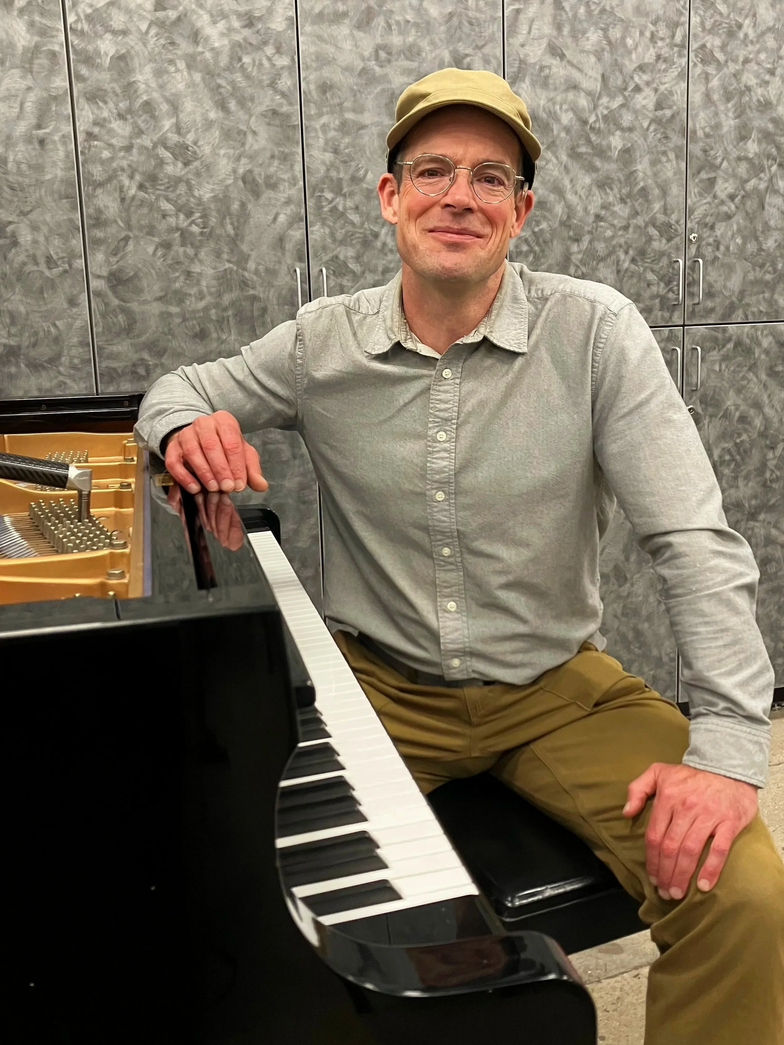 Matthew Thornton Tucson Piano Tuner seated at grand piano