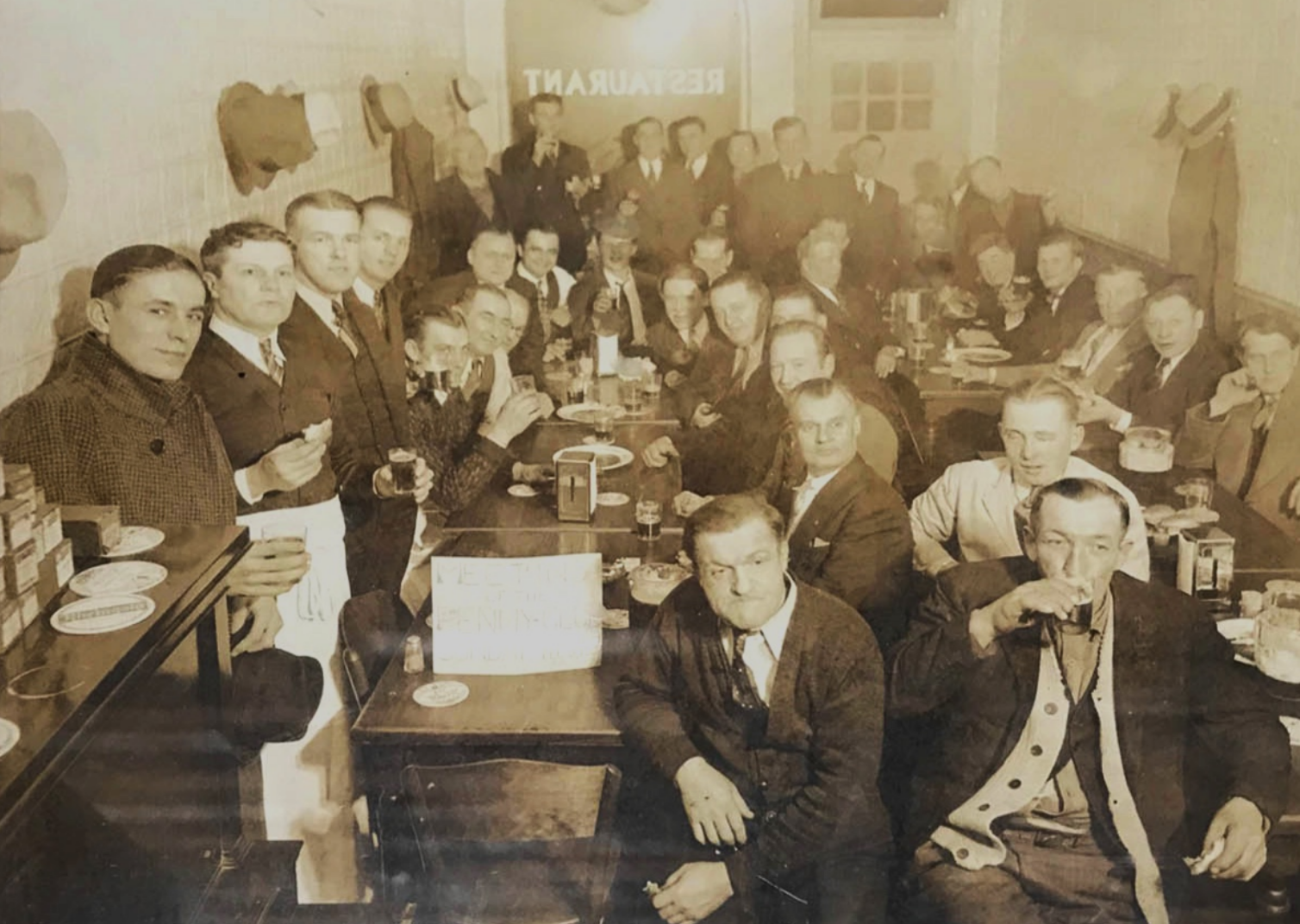 People gathered drinking beer in early 1900's