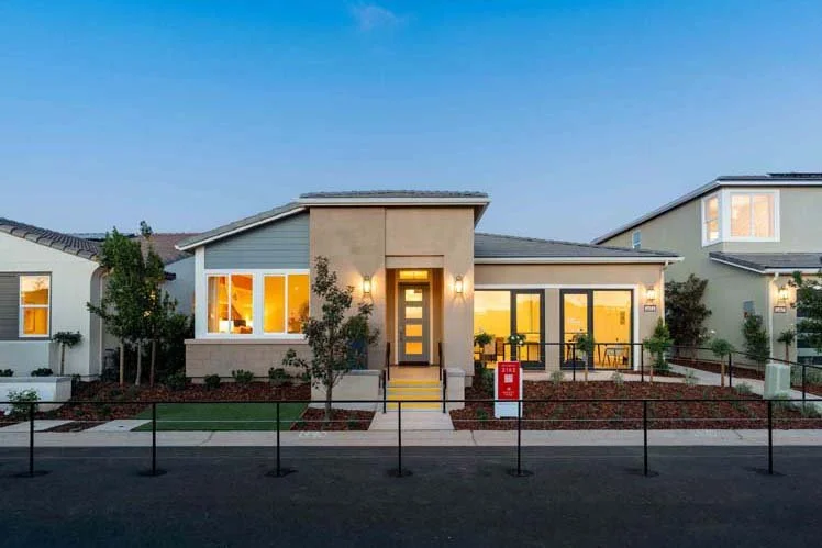 Modern suburban house with large windows, front yard, and a red fire hydrant