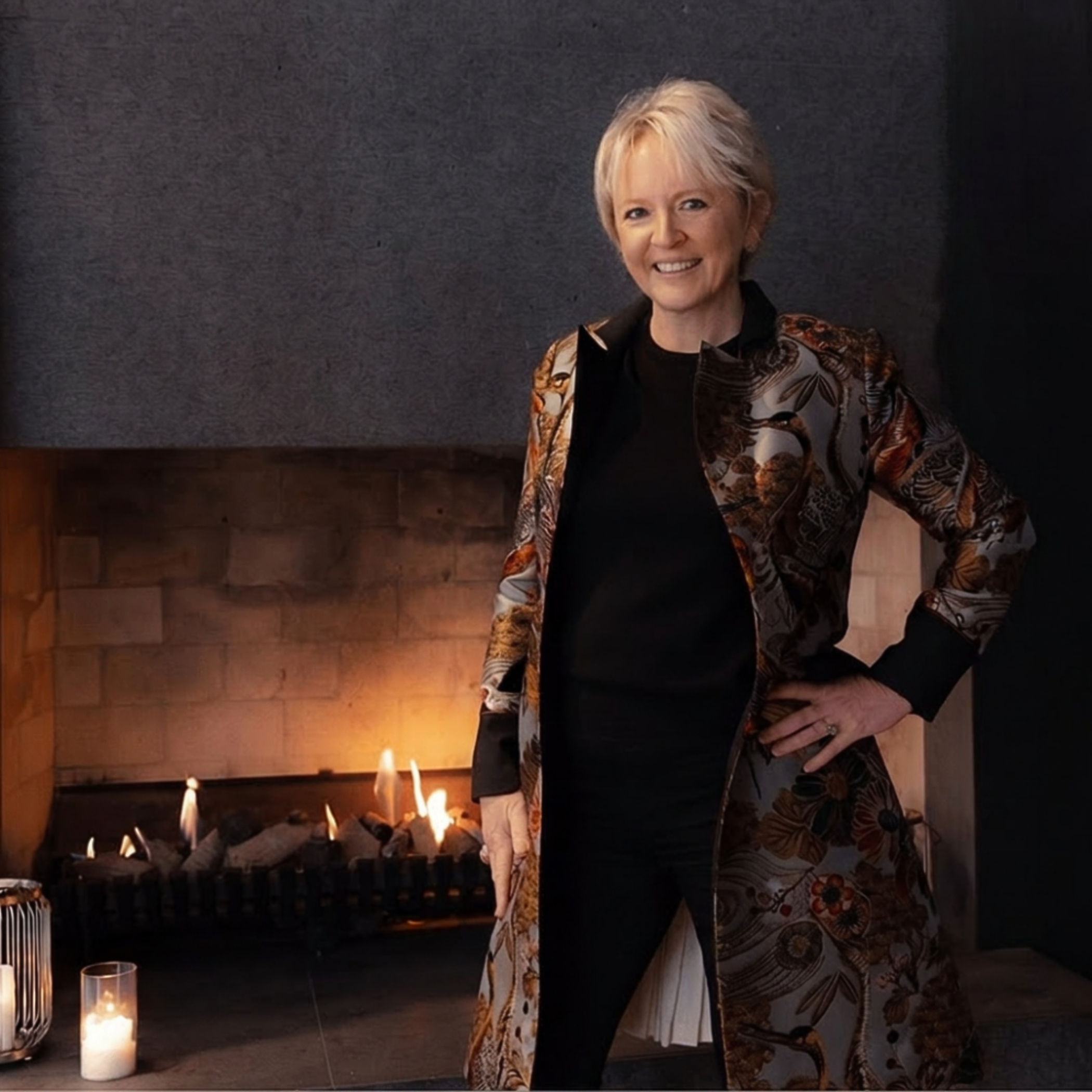 Elisabeth Ric Hansen at The Next Move is Yours Summit by Sheer Negotiations and Noa Sheer wearing a Trelise Cooper coar, standing near a fireplace with candles