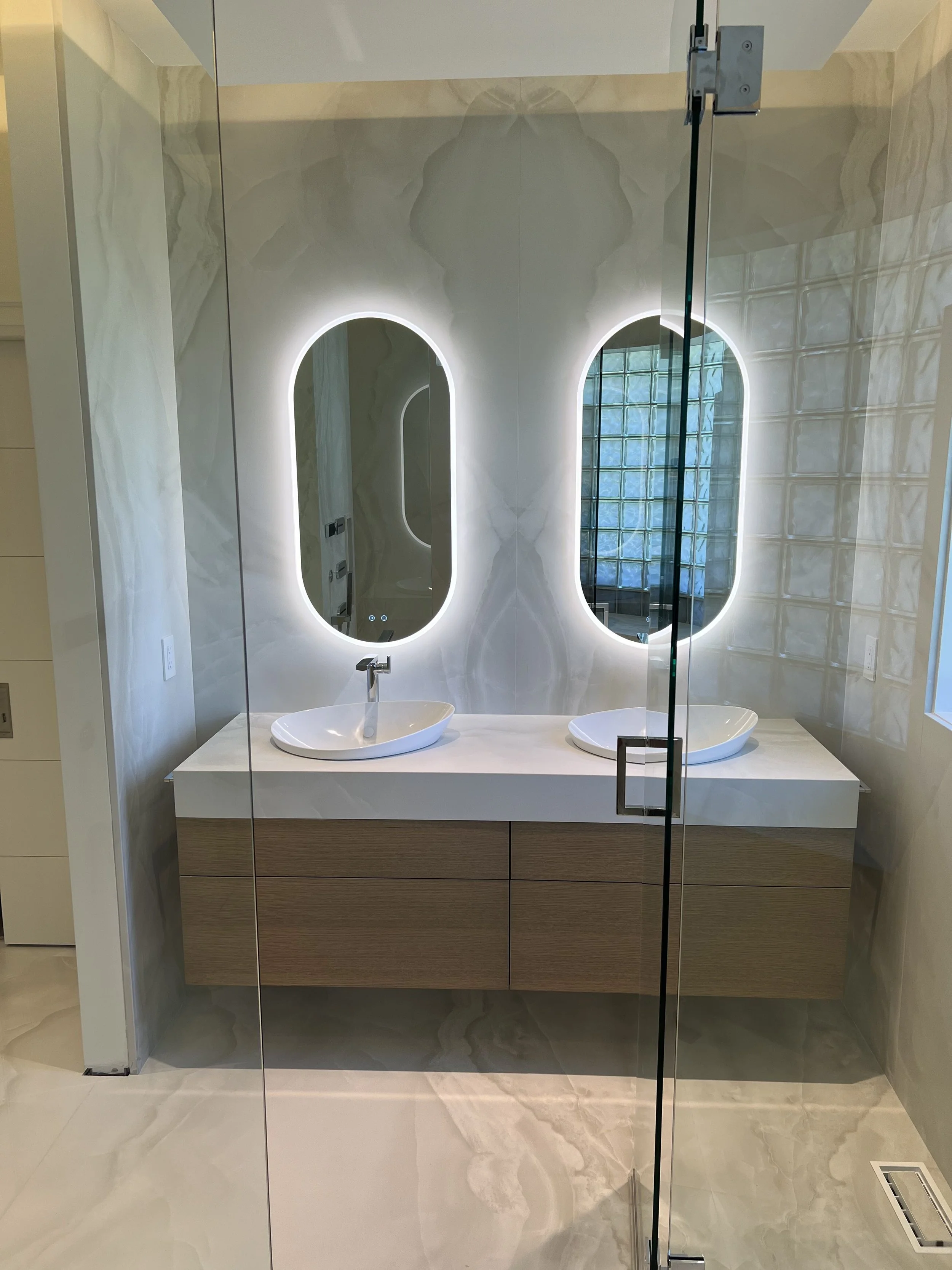 Double vanity bathroom with tiled walls