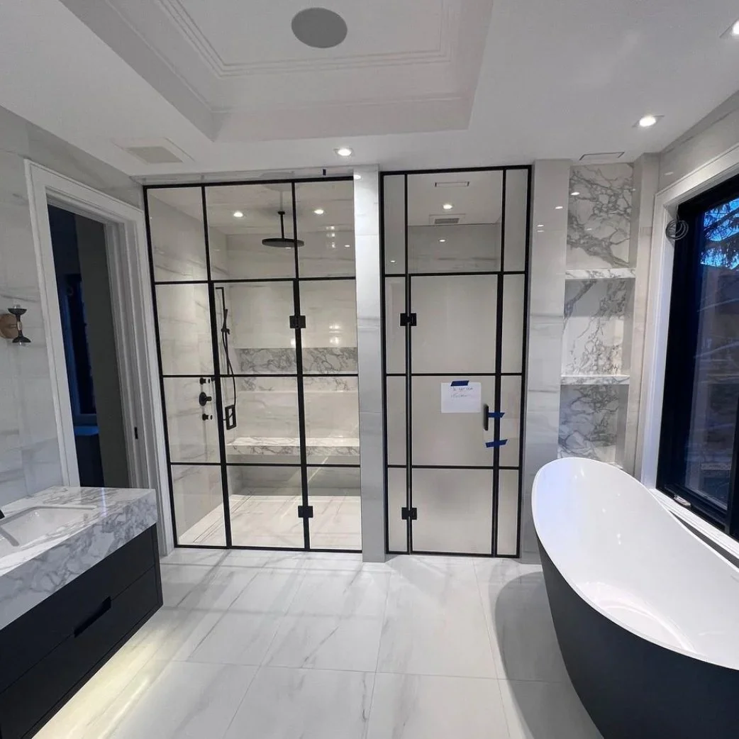 Bathroom renovation with black rimmed glass shower