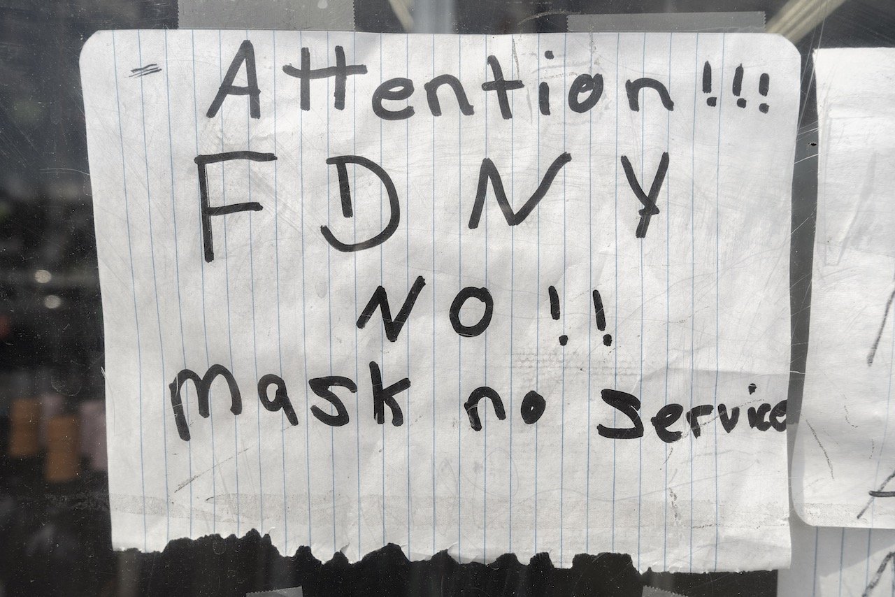 Sign warning NYC firefighters to wear masks when entering this liqourstore. Discount Liqours, 1045 E. 163rd St., Bronx, June 15, 2020