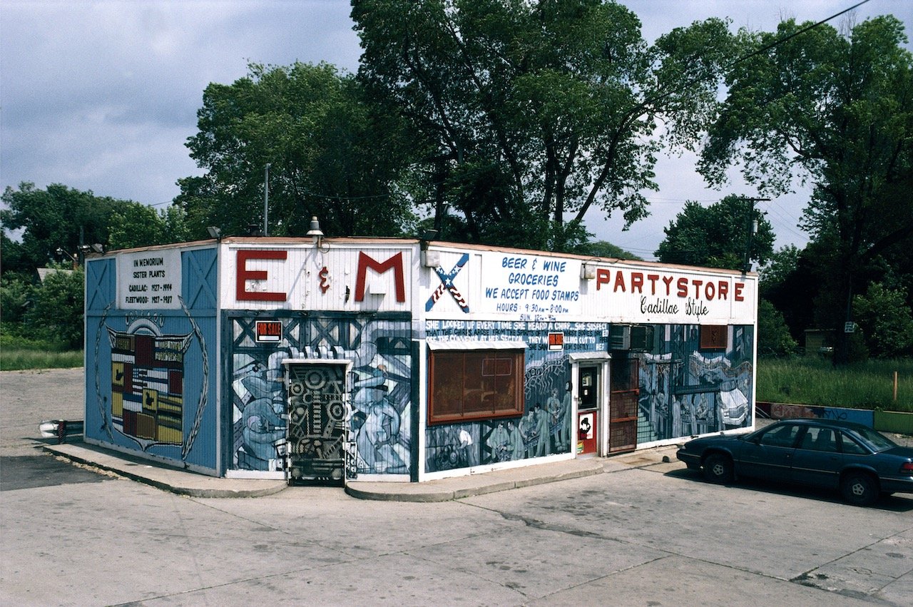E and M Cadillac Style Party Store with Diego Rivera-influenced assembly line mural with a memorial to closed auto plants. Scotten Street at Toledo Street, Detroit, 2001