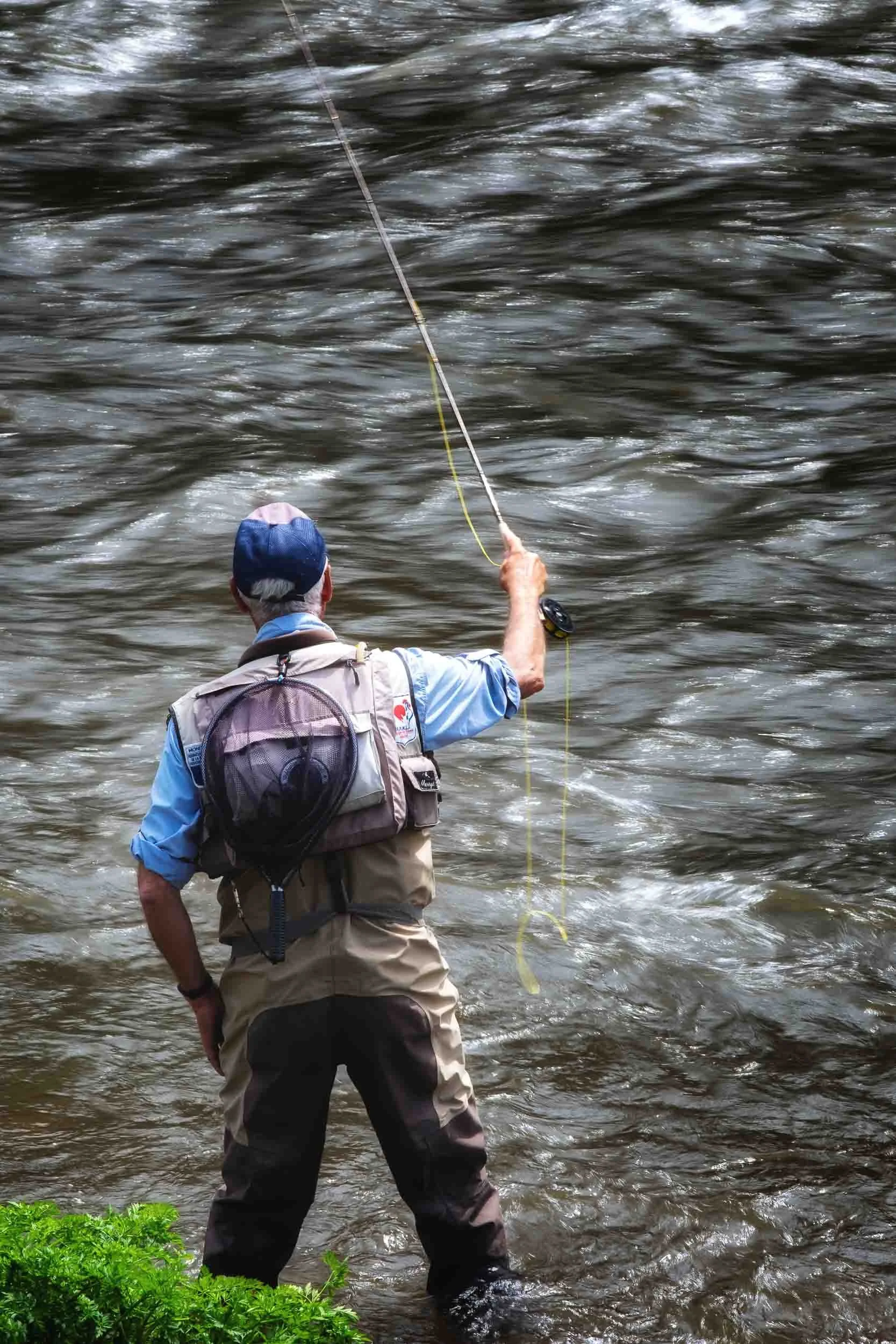Escena de pesca en el río Eo entre Galicia y Asturias, fotografía de naturaleza fluvial y tradición de ribera.