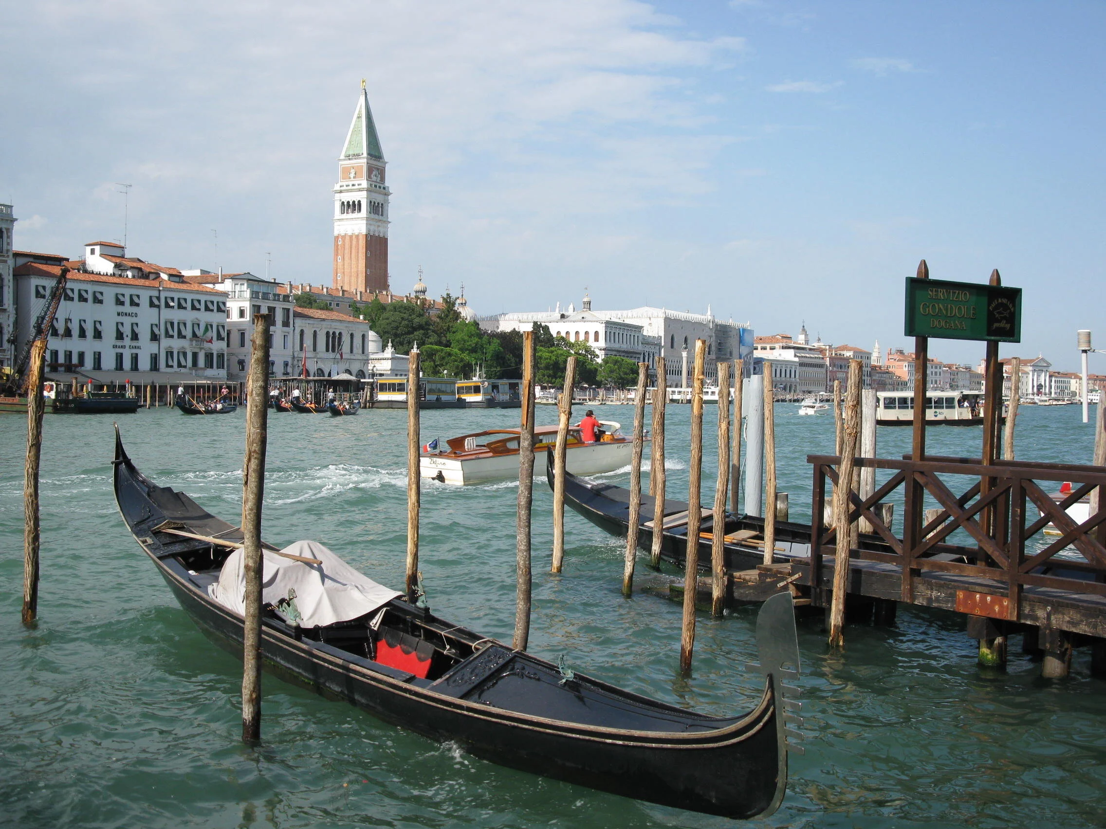 Gondolas on the Venice waterfront with St. Mark's Campanile and Doge's Palace across the water