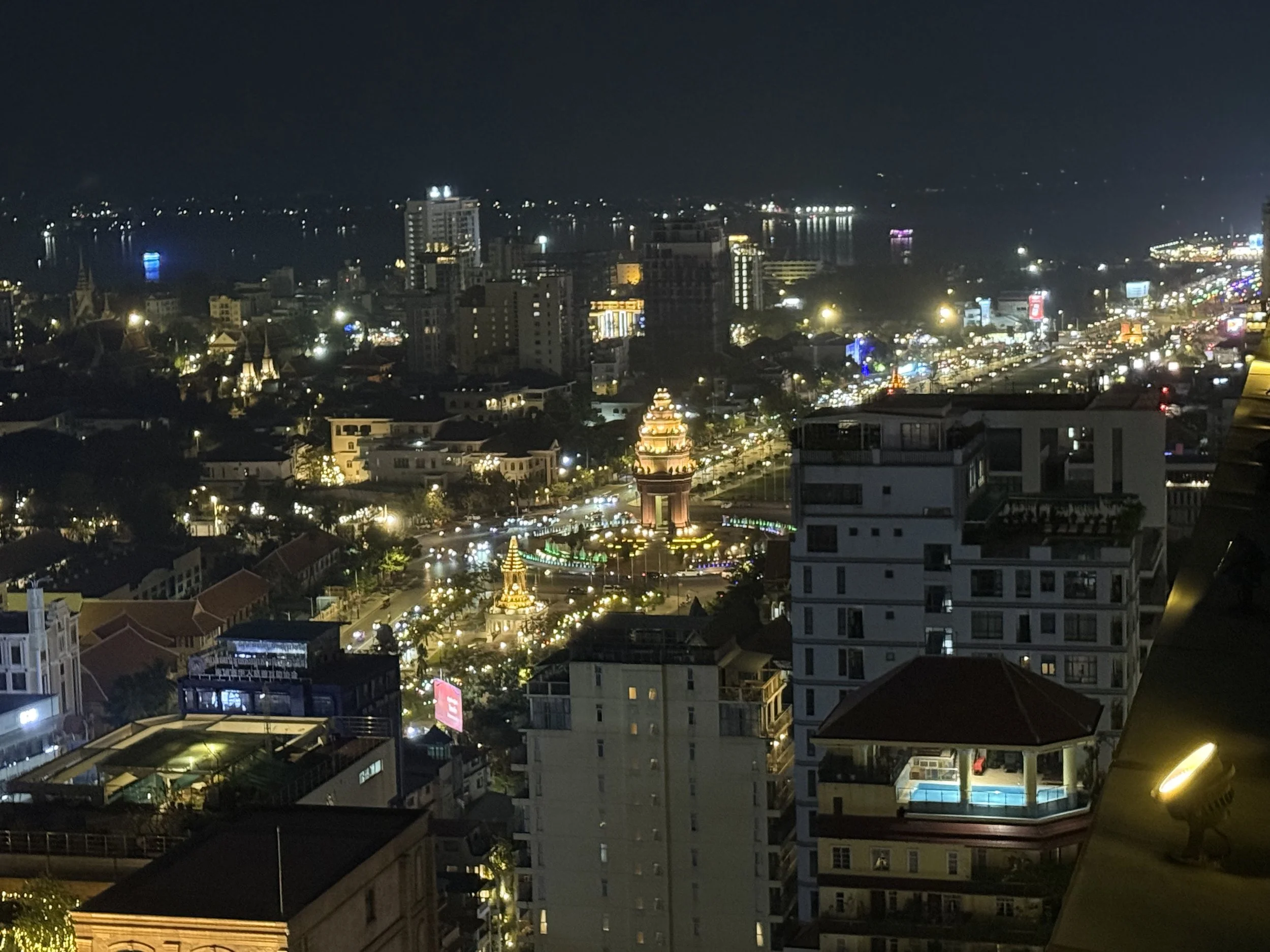 View of the Independence Monument at night from the Raffles Hotel