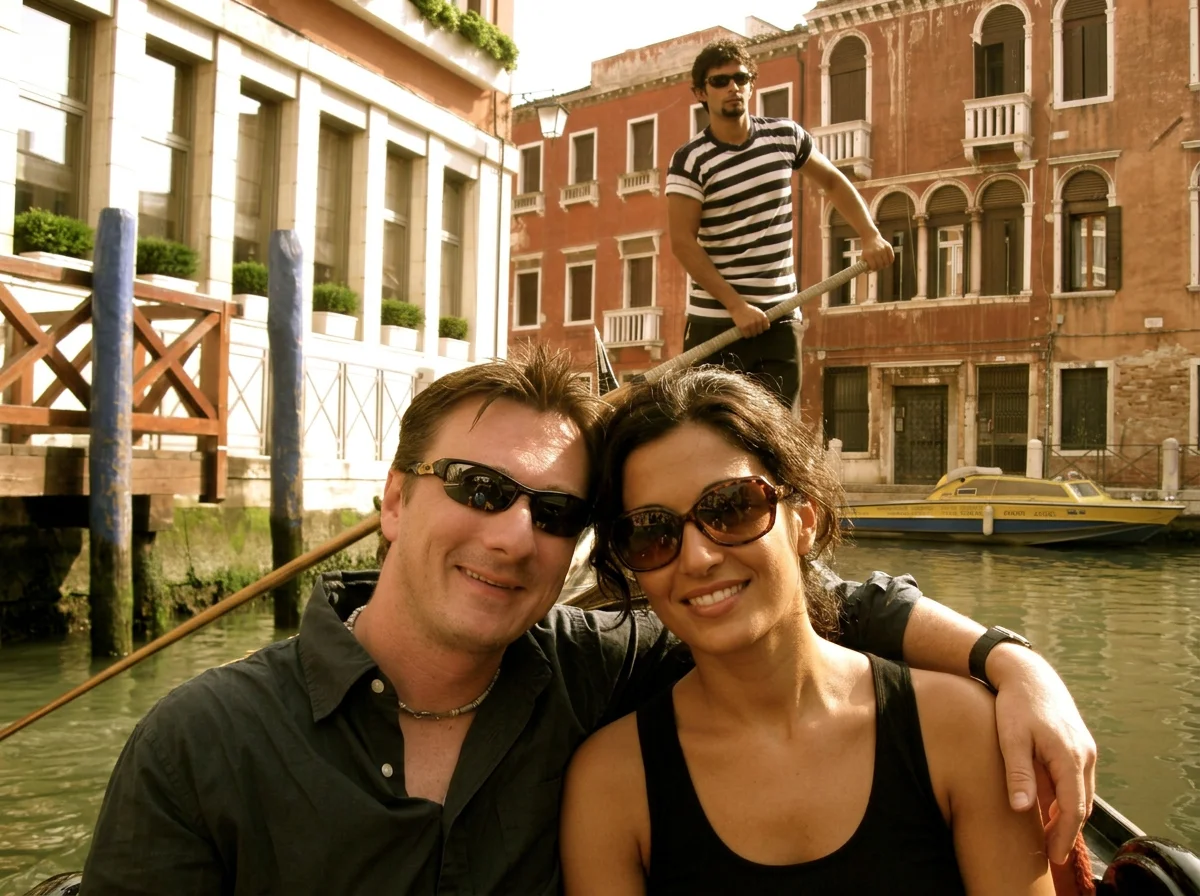 Travelers enjoying a gondola ride on a canal in Venice, Italy