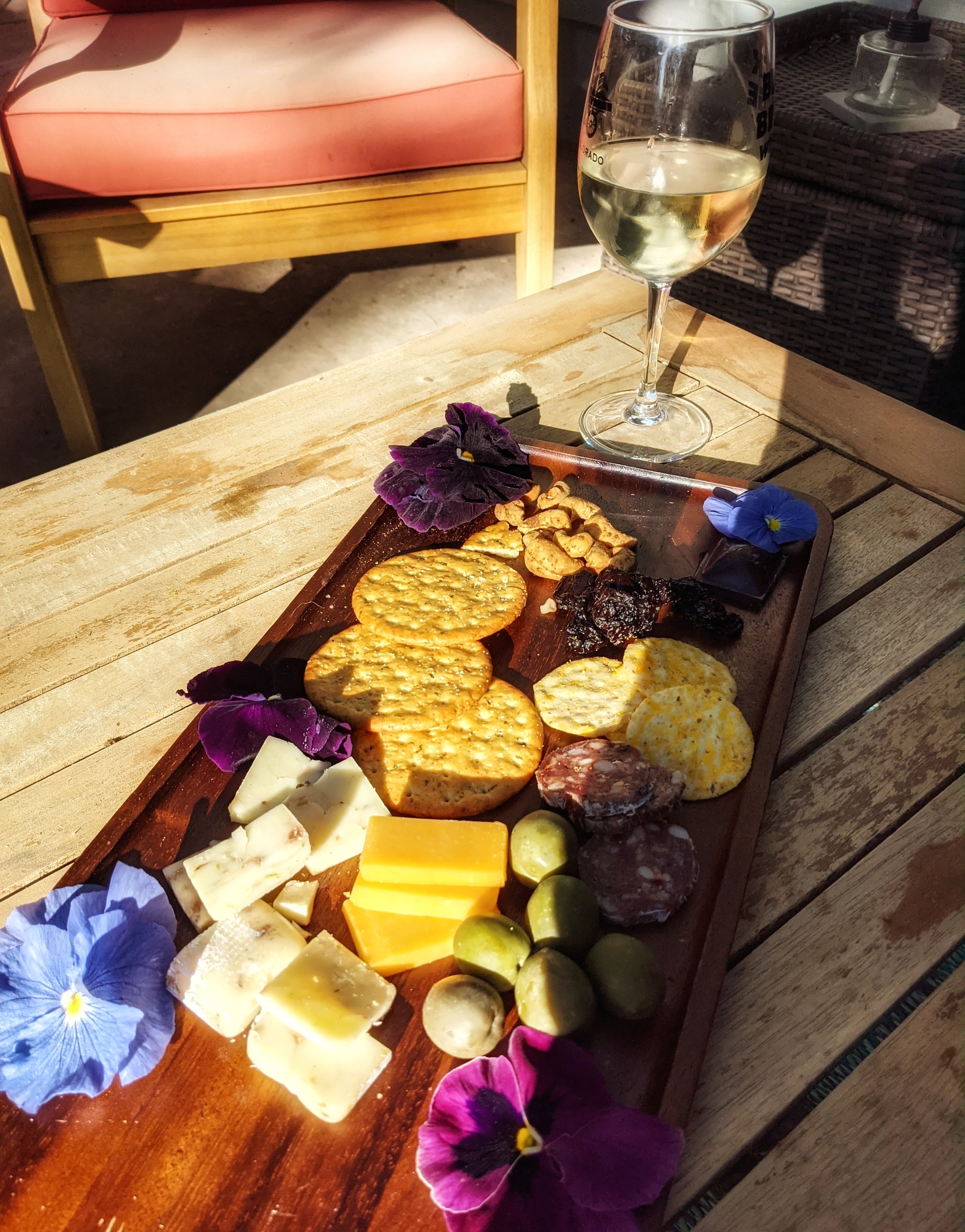 charcuterie board with edible flowers.jpeg