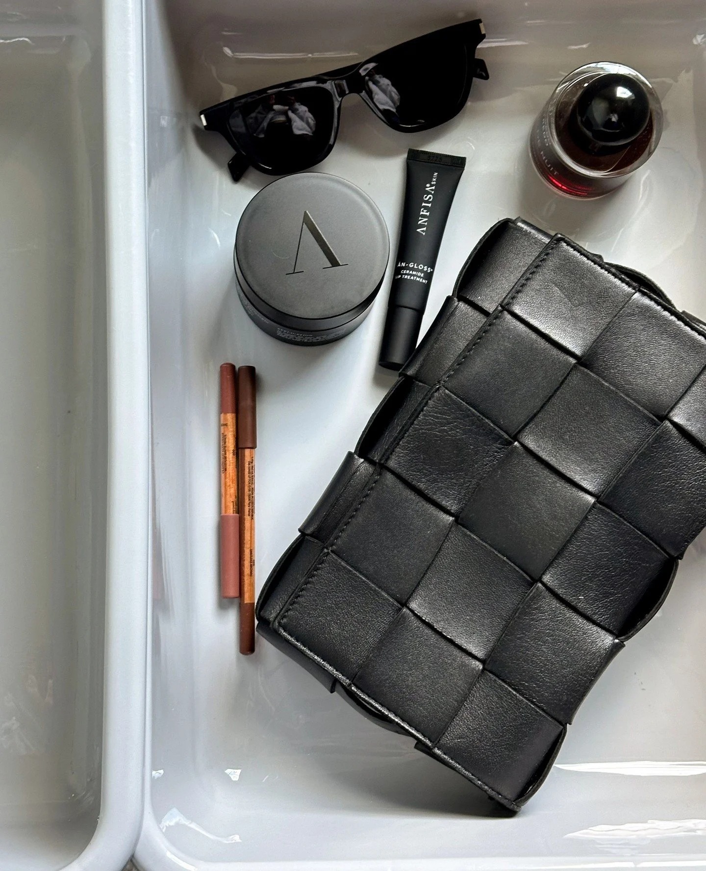 Travel basics.⁠
⁠
Never without at least one tube of my favorite An-Gloss Ceramide Lip Treatment. 💋