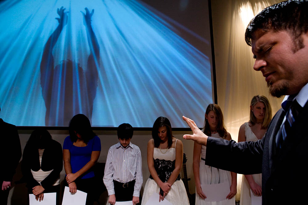 Associate Pastor J.R. Hall prays over the purity ring ceremony participants after they received their rings and "True Love Waits" commitment certificates on February 13, 2008 at the Full Life Assembly of God in Franklin, TN. The ceremony involves teenage boys and girls and their parents who take a pledge to abstain from sex before marriage. The participants complete 5 classes before graduating in the ceremony where they receive a ring as a symbol of their promise to God and their parents and a certificate.