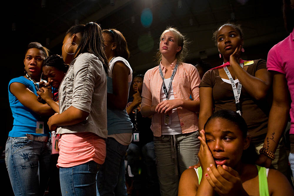 Tanyetta Hampton, 17, is comforted by friends during a Christian concert at the Destiny World Church June 14 in Austell, GA. Young children, teenagers and their parents or guardians came together for three days to promote abstinence. Issues like STDs, peer pressure, teen pregnancy, molestation and abuse were also main topics of panel discussions. The Holywood Retreat concluded with a Purity Ring Ceremony where each participant pledged to keep their virginity or to no longer participate in sex outside of marriage by wearing a "purity ring" on their wedding finger until the day it is replaced by a wedding ring. The three day event featured ministers and lay speakers, a fashion show that illustrated how one can remain modest and fashionable, a religious concert as well as other activities that entertained a predominantly young and energetic group.