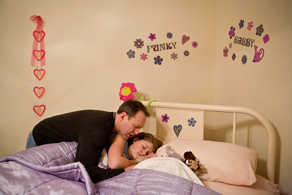 Scott Forhetz prays over his daughter as the family winds down after an evening at the church where their entire family participated in a purity ring ceremony on February 13, 2008 in Brentwood, TN. The ceremony involves teenage boys and girls and their parents who take a pledge to abstain from sex before marriage. The participants complete 5 classes before graduating in the ceremony where they receive a ring as a symbol of their promise to God and their parents and a certificate.