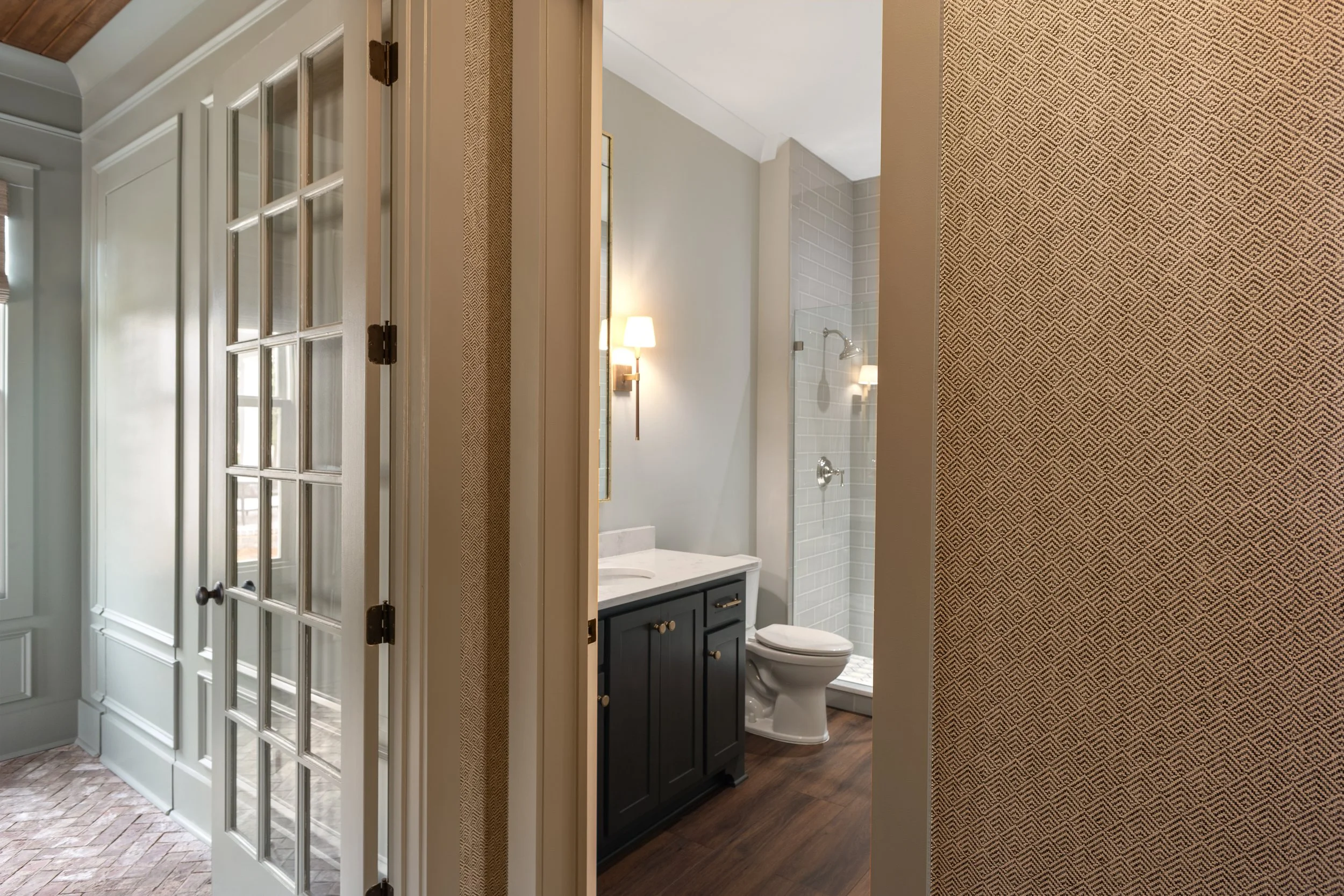 Bathroom remodel with dark vanity and patterned wallpaper in Columbus Georgia
