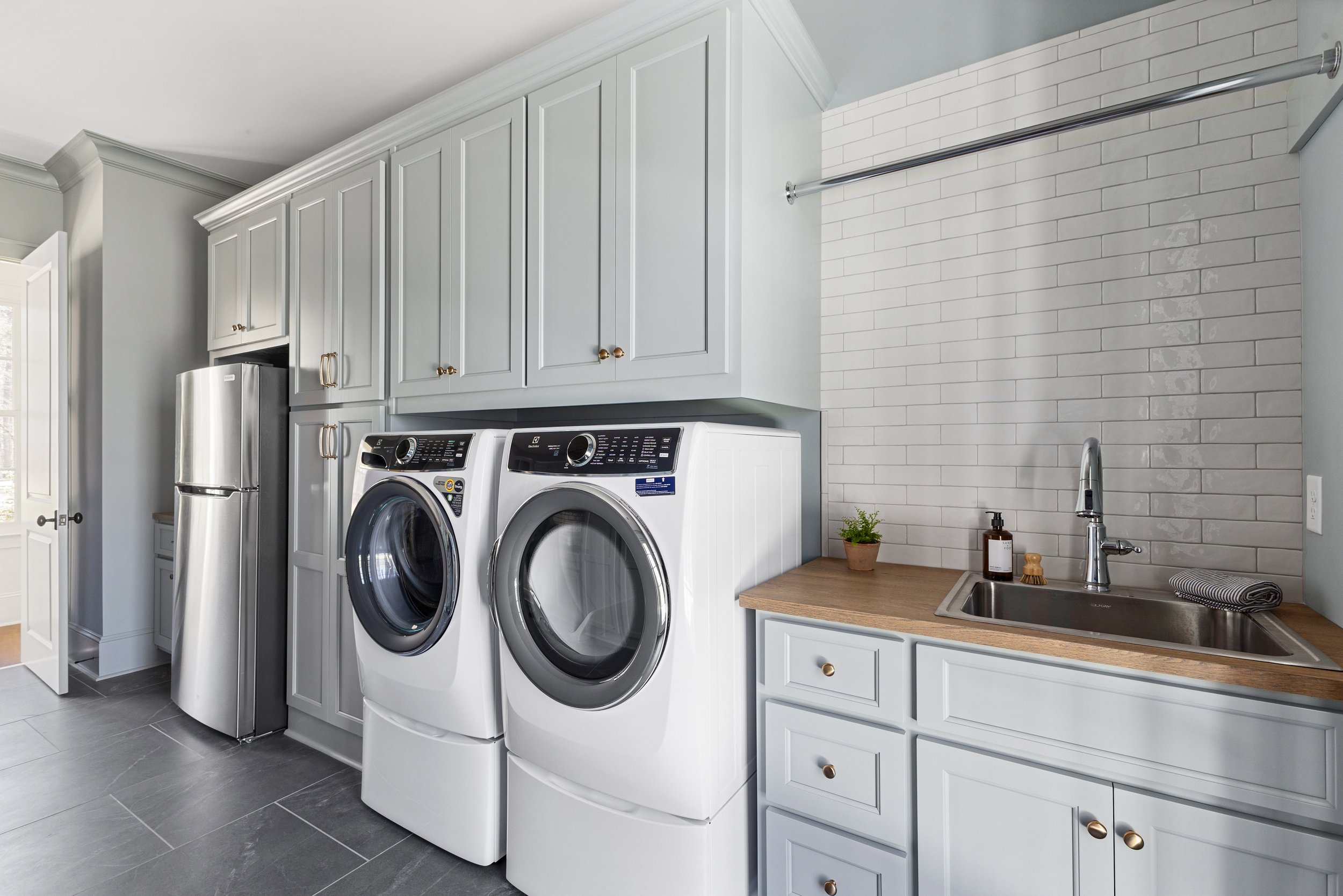 Laundry room remodel with custom cabinets and sink in Columbus GA