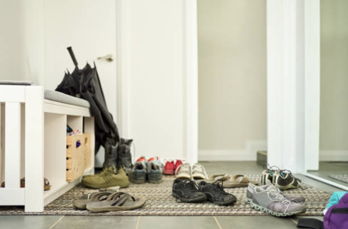 Floor cluttered with shoes.