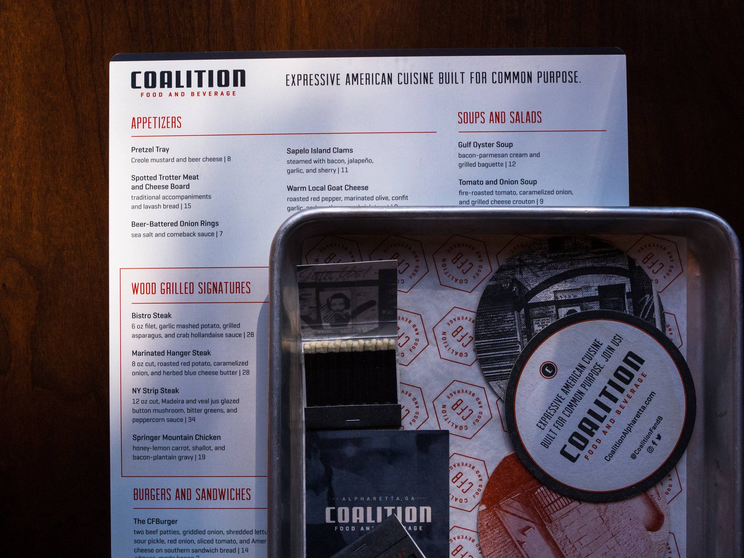 Coalition Food and Beverage Menu with tin of branded collateral