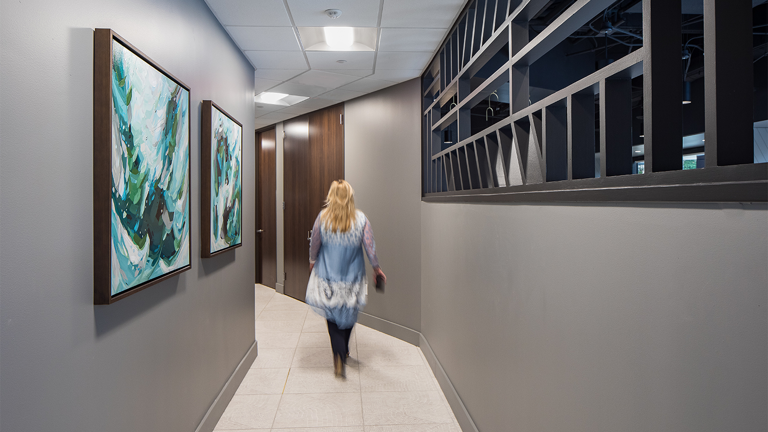 1800 West Loop Hallway with abstract paintings on wall
