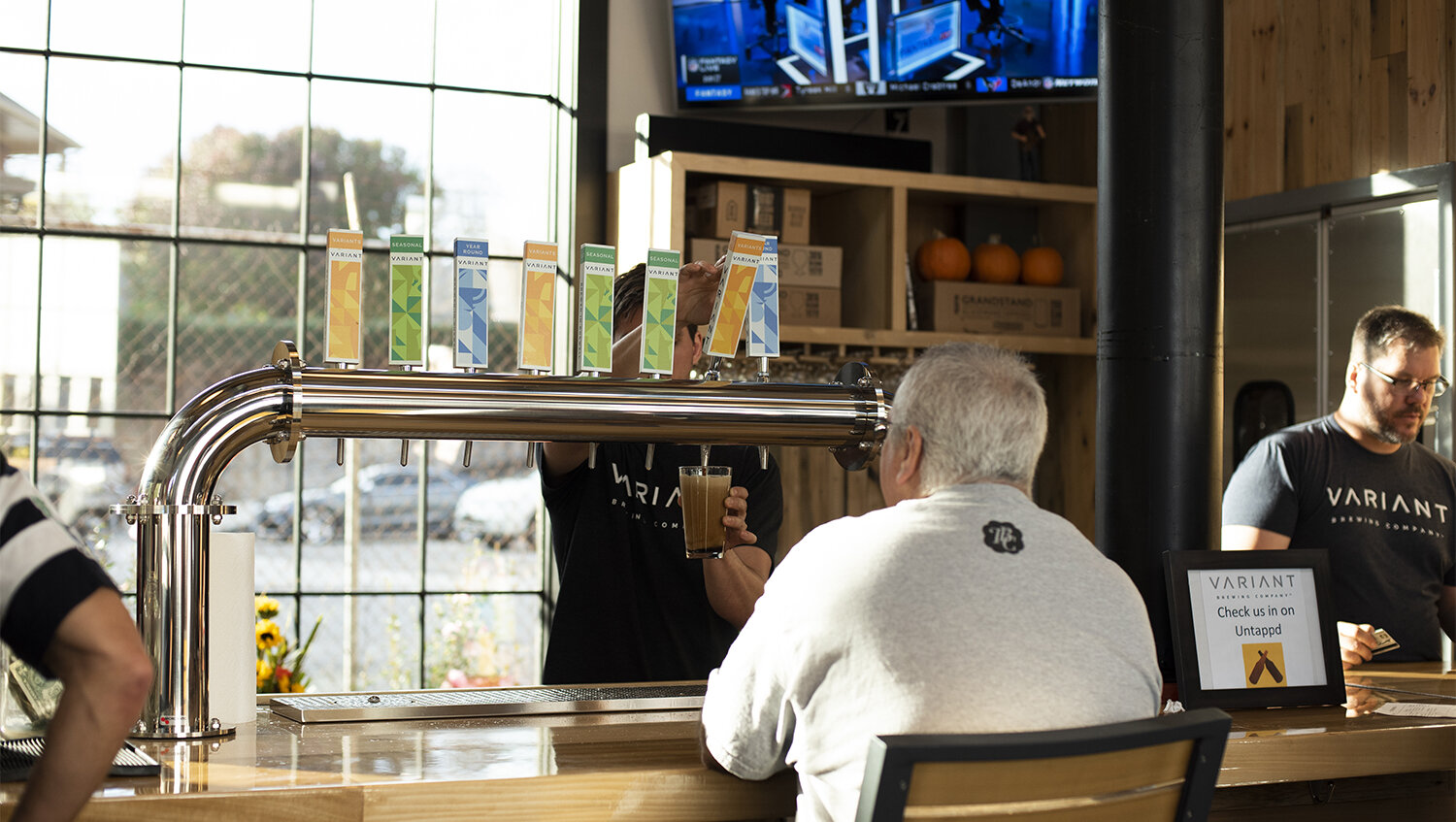 Variant Brewing branded beer taps with customer at bar